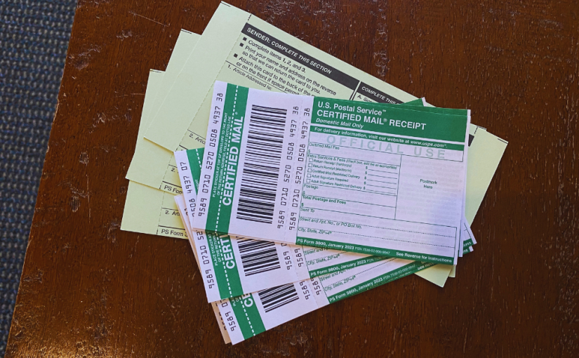 A stack of certified mail labels and green cards on top of each other.