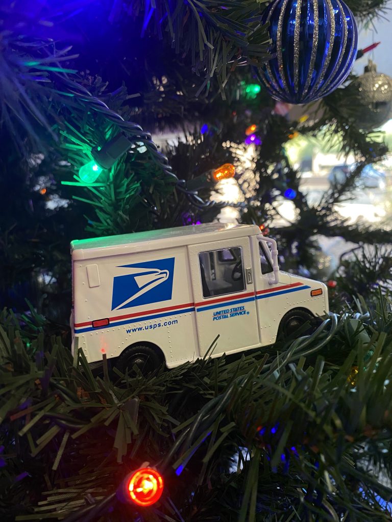 mail truck for the usps postal service in a christmas tree for mailing on postal holidays