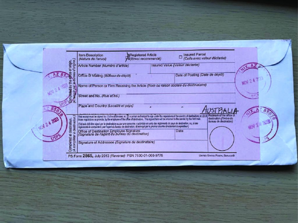 Registered Mail pink slip on an envelope of an international letter