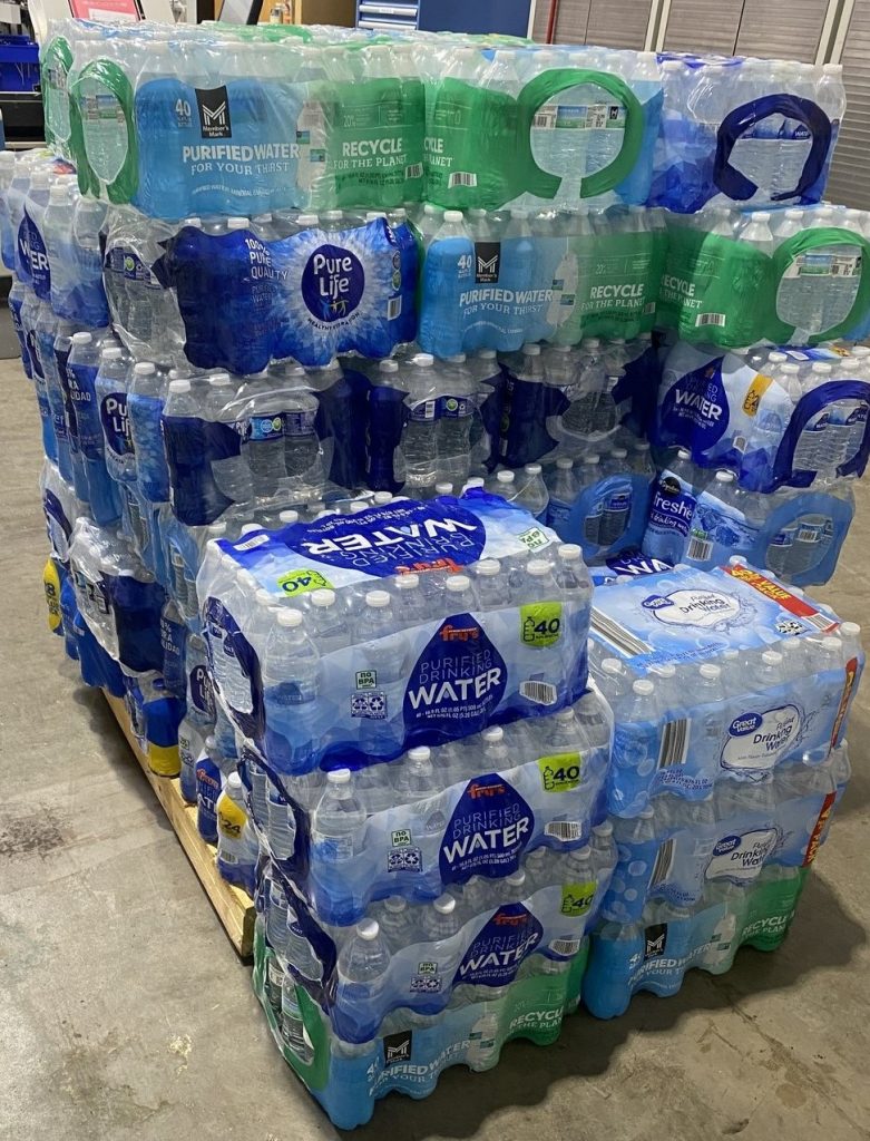 Cases of water bottles on a pallet to be donated from our online print and mail location in Scottsdale