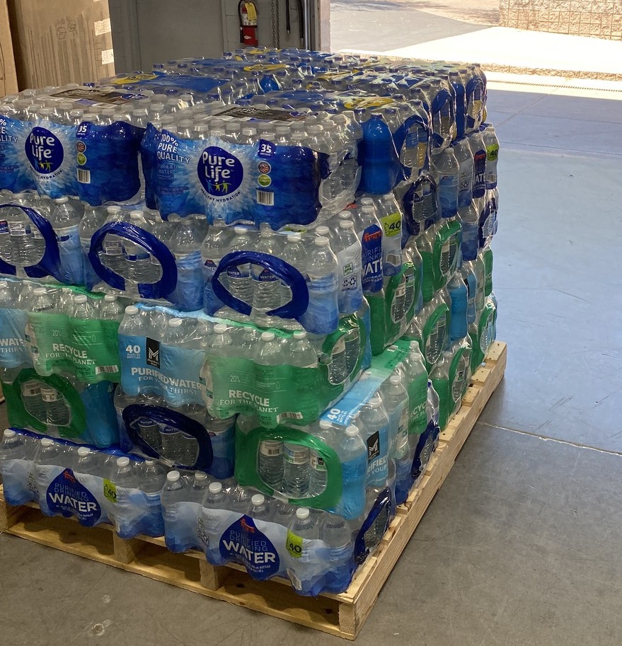 A stack of cases of water at our print and mailing facility
