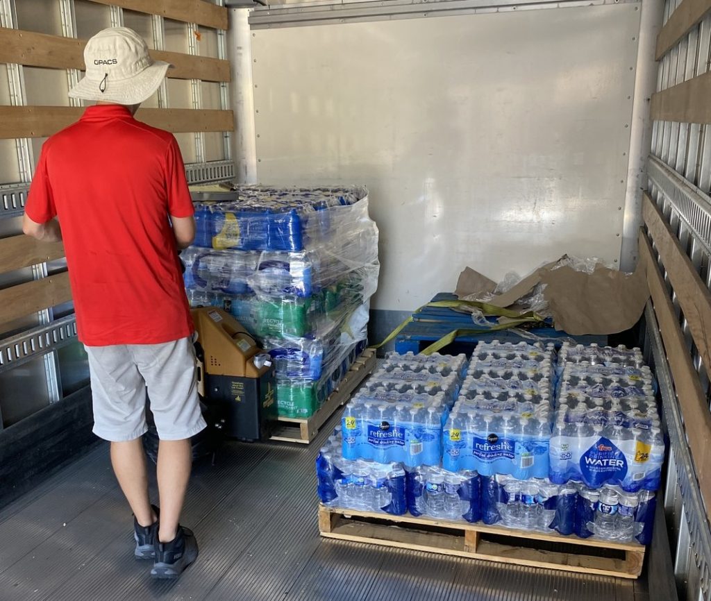OPACS driving loading in cases of water on a pallet into the truck